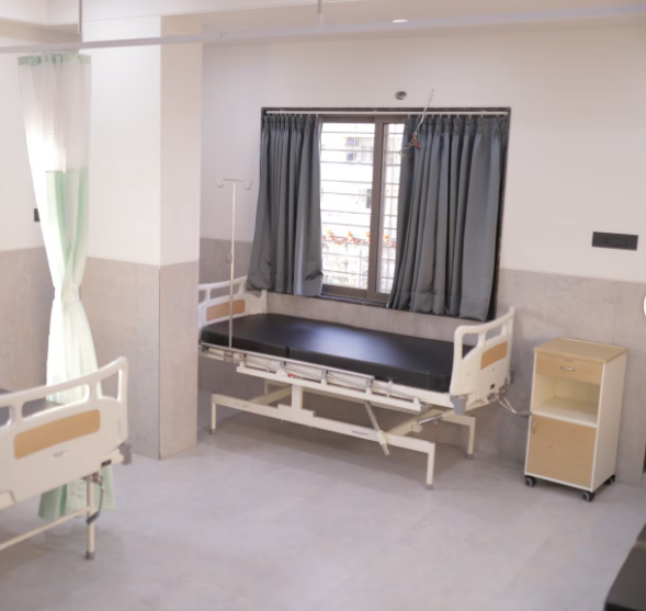 Patient room with hospital bed at New Life Hospital